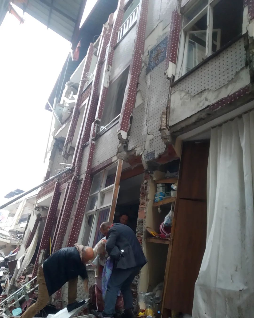 ▲地震后，人们从倒塌的房子中拿出被子和衣物。受访者供图